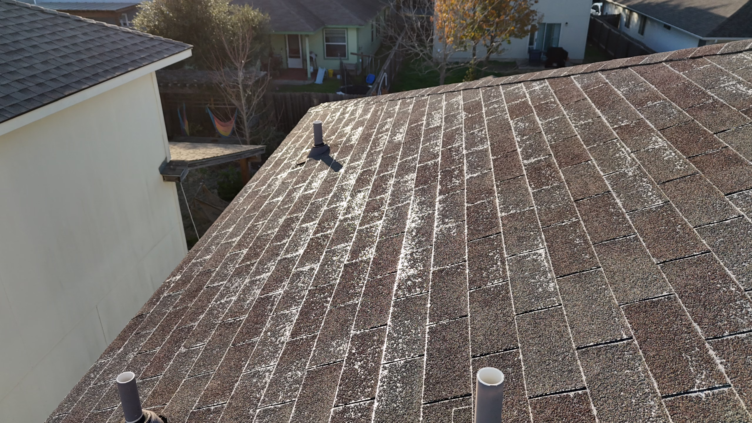 shiny roof surface from granule loss