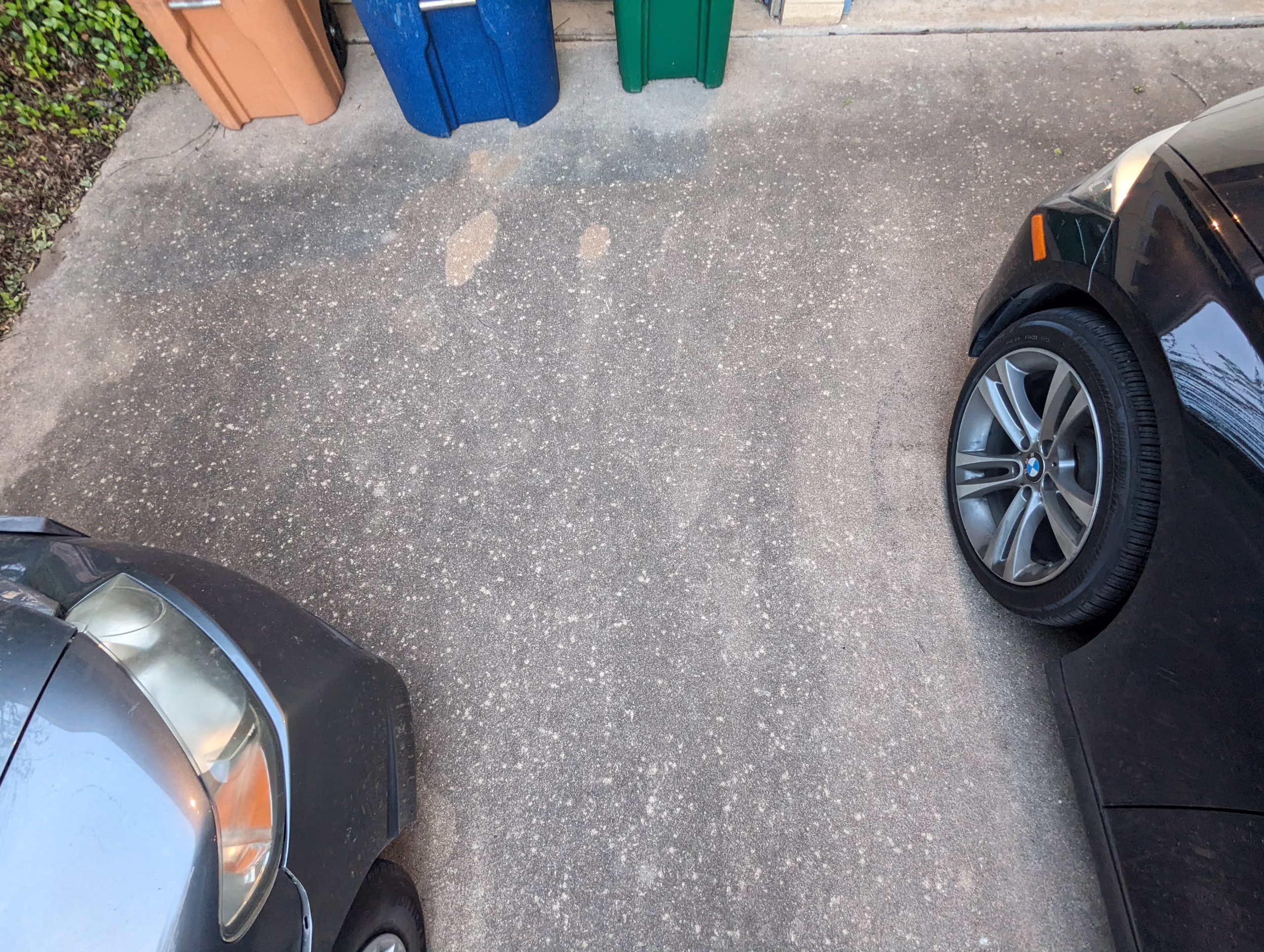 hail spatter marks on concrete driveway and electrical box